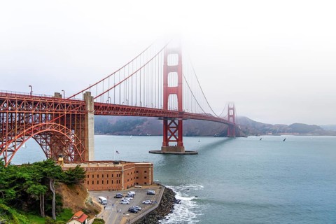 1937 Golden Gate Bridge in the mist, red Art Deco suspension bridge linking San Francisco to Marin