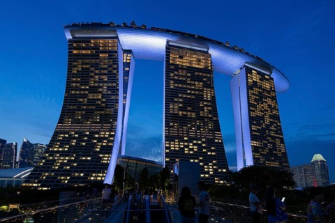 Marina Bay Sands, MBS, luxury 5-star hotel and integrated resort illuminated at dusk in Downtown