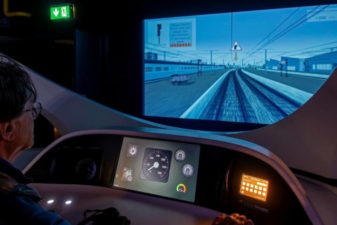 Visitor operating locomotive driving simulator at Train World, railway museum in Schaerbeek,