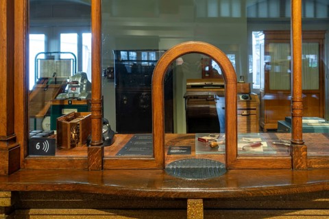 Vintage ticket counter in former ticket hall at the Schaerbeek railway station at Train World,