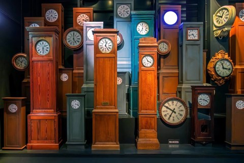 Collection of antique wooden railway station clocks at Train World, railway museum in Schaerbeek,