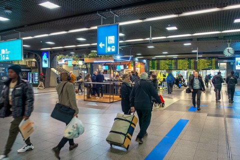 Travelers, commuters, tourists in the main hall of the NMBS Brussels-South railway station, Gare de