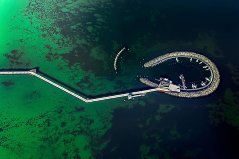 Aerial view over Seebrücke, pier and marina with boats at seaside resort Prerow along the Baltic