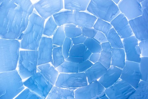 Interior of igloo showing roof built from stacked snow bricks in a catenary, curved shape