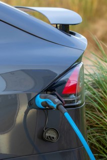 Close-up of electric vehicle / EV recharging at public charging station / loading point for