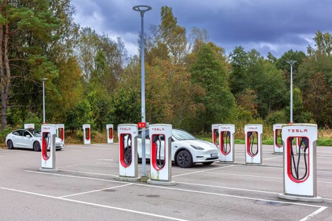 Parking area with public charging station / loading points from Tesla, network of rapid chargers
