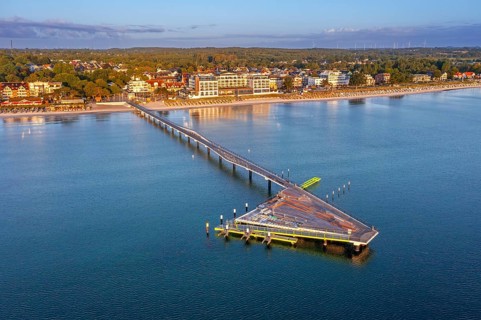 Aerial view over Seebrücke / pier and sandy beach at seaside resort Scharbeutz along the Baltic