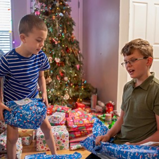 Denver, Colorado - Brothers open Christmas presents on Christmas morning