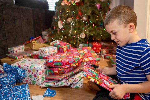 Denver, Colorado - A boy opens Christmas presents on Christmas morning