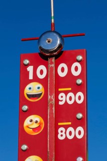 Close-up of High Striker game of strength with numbered score levels at Fun Show traveling