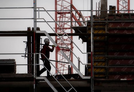 Construction site, scaffolding work on a large construction project, apartments and commercial
