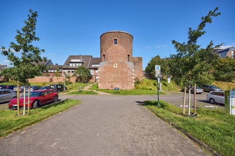 Holkensturm, historic city fortification, tower, parking lot with cars, residential building,