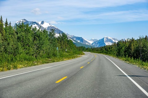 Road through taiga and mountainous landscape, picturesque landscape on Richardson Highway, Alaska,