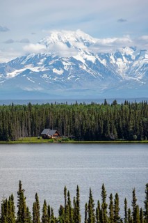 House on Lake Willow Lake, Taiga landscape with high glaciated mountain peak Mount Drum, Wrangell