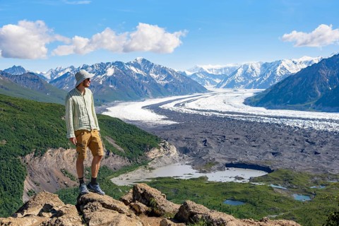 Young man enjoying the view, view of impressive mountain landscape with Matanuska glacier and