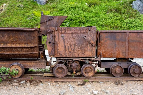 Old rusted mine trucks from the former Gold Mine Independence Mine in mountainous landscape,