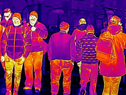 Thermal image or thermography, symbolic photo, interpolated. People traveling in urban areas.