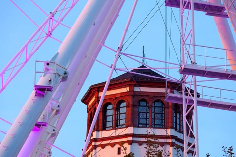 Rhine promenade with illuminated Ferris wheel and castle tower at dusk, Düsseldorf, North
