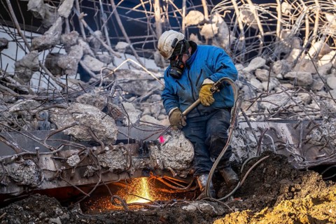 Workers with cutting torches demolishing the 120-meter long motorway bridge of the A516, across