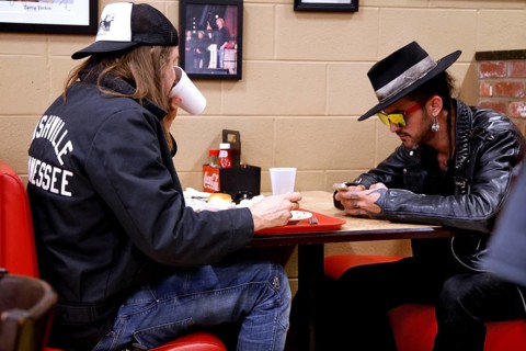 Two people eat and talk at a table in Arnold's Country Kitchen, Nashville, Tennessee, USA