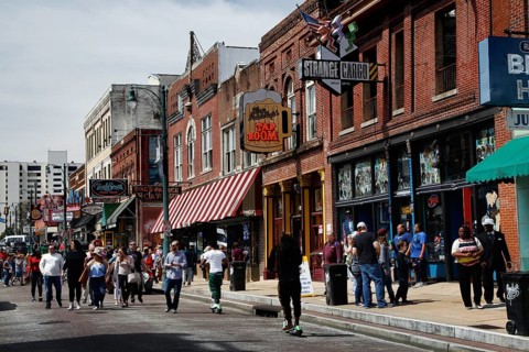 Bustling Beale Street with strollers and shops in Memphis, Memphis, Tennessee, USA
