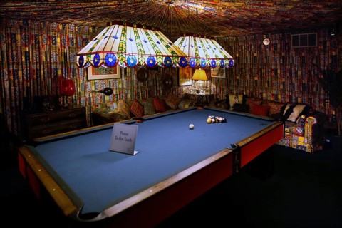 Billiard room with blue table and bright strip lights, cozy atmosphere in Graceland, Memphis,