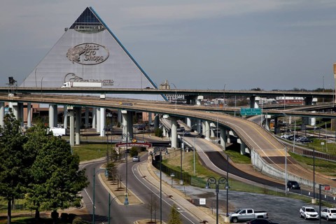 Futuristic pyramid next to a complex network of roads and bridges, Memphis, Tennessee, USA