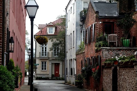 Idyllic narrow alley with historic buildings and vegetation in Charleston, Charleston, South