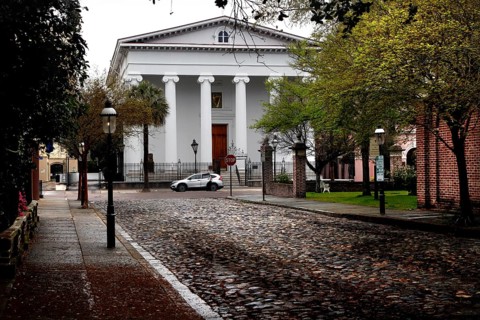 Historic building with pillars on a paved street in Charleston, Charleston, South Carolina, USA