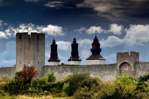 Medieval city wall of Visby with towers and dramatic sky, Visby, Gotland, Sweden