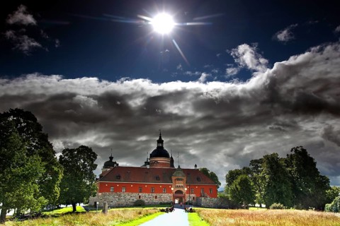 Gripsholm Castle in Mariefred in sunlight and dramatic clouds, Mariefred, Södermanland, Sweden