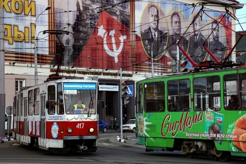 Colourful trams in front of Soviet propaganda posters, Kaliningrad, Russia