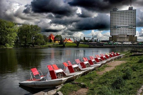 Boats on the castle pond with the imposing House of Councils in the background, Kaliningrad,