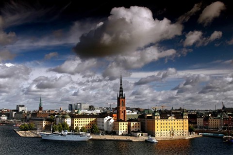 View of Riddarholmen in Stockholm with distinctive church tower and dramatic sky seen from