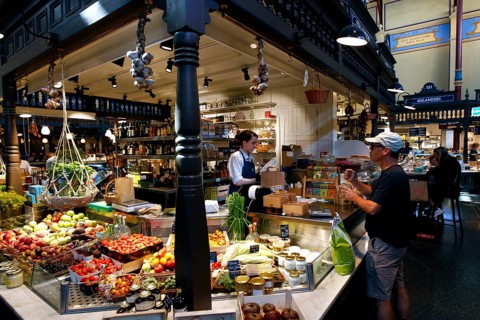 Lively market hall in Östermalm with a variety of food stalls and hustle and bustle, Stockholm,