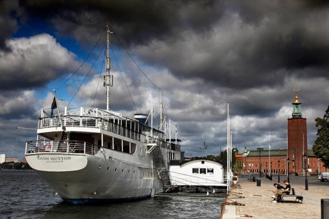 Stockholm City Hall on Kungsholmen with adjacent harbor and dramatic sky, Stockholm, Kungsholmen,