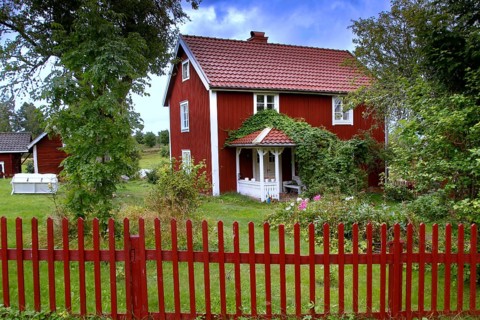 Red house surrounded by trees in an idyllic landscape, Svedstorp, Sweden
