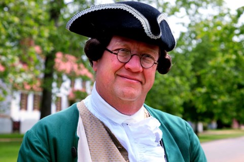 Man in authentic colonial clothing smiling relaxed at camera, friendly portrait, Williamsburg,