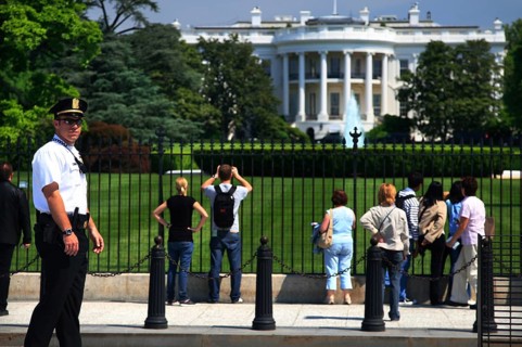 Visitors view the White House from a public area, Washington D.C, USA