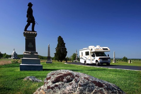 A memorial stands in front of a motorhome in an open, green area of Gettysburg National Military