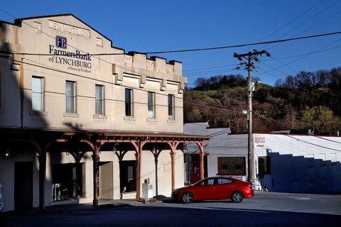 City scene with historic buildings and a red car in Lynchburg, Lynchburg, Tennessee, USA