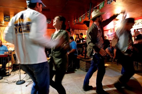 Couple dancing with energy in Fred's Lounge, Mamou, Louisiana, USA