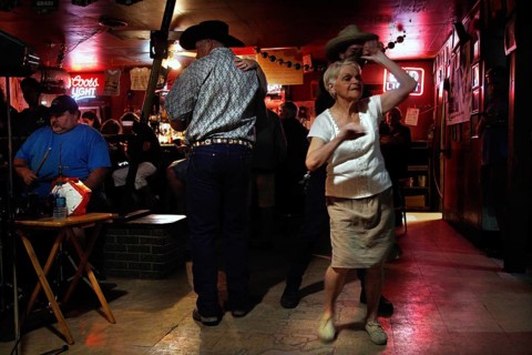 An elderly dancer dances in Fred's Lounge, Mamou, Louisiana, USA