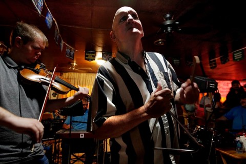 A triangle player performs with a violinist in the Cajun band, Mamou, Louisiana, USA
