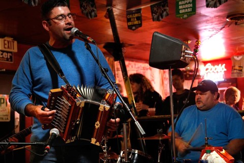 A harmonium player and singer perform in the Cajun band, Mamou, Louisiana, USA