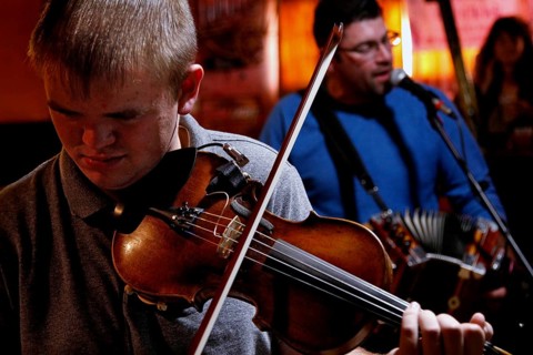A violinist and singer perform in the Cajun band in Fred's Lounge, Mamou, Louisiana, USA