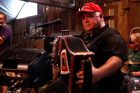Accordion player on stage in the rustic setting of Randolph's Restaurant, Lafayette, Louisiana, USA