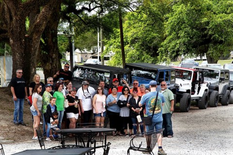 Group of visitors in front of vehicles at the McIlhenny Tabasco factory on Avery Island, Avery