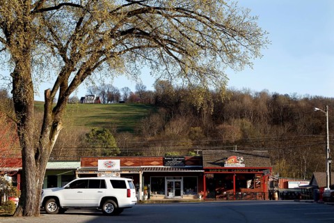 A rural road with shops and trees near Lynchburg, Lynchburg, Tennessee, USA