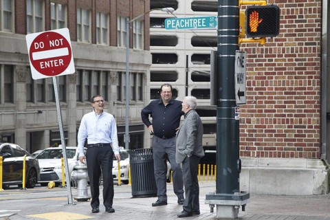 People stand on a street corner in Downtown Atlanta on Peachtree Street, Atlanta, USA